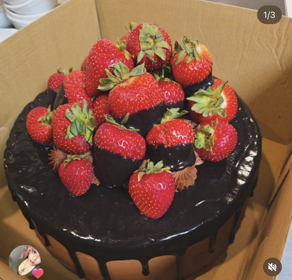 Chocolate drip cake topped with fresh strawberries