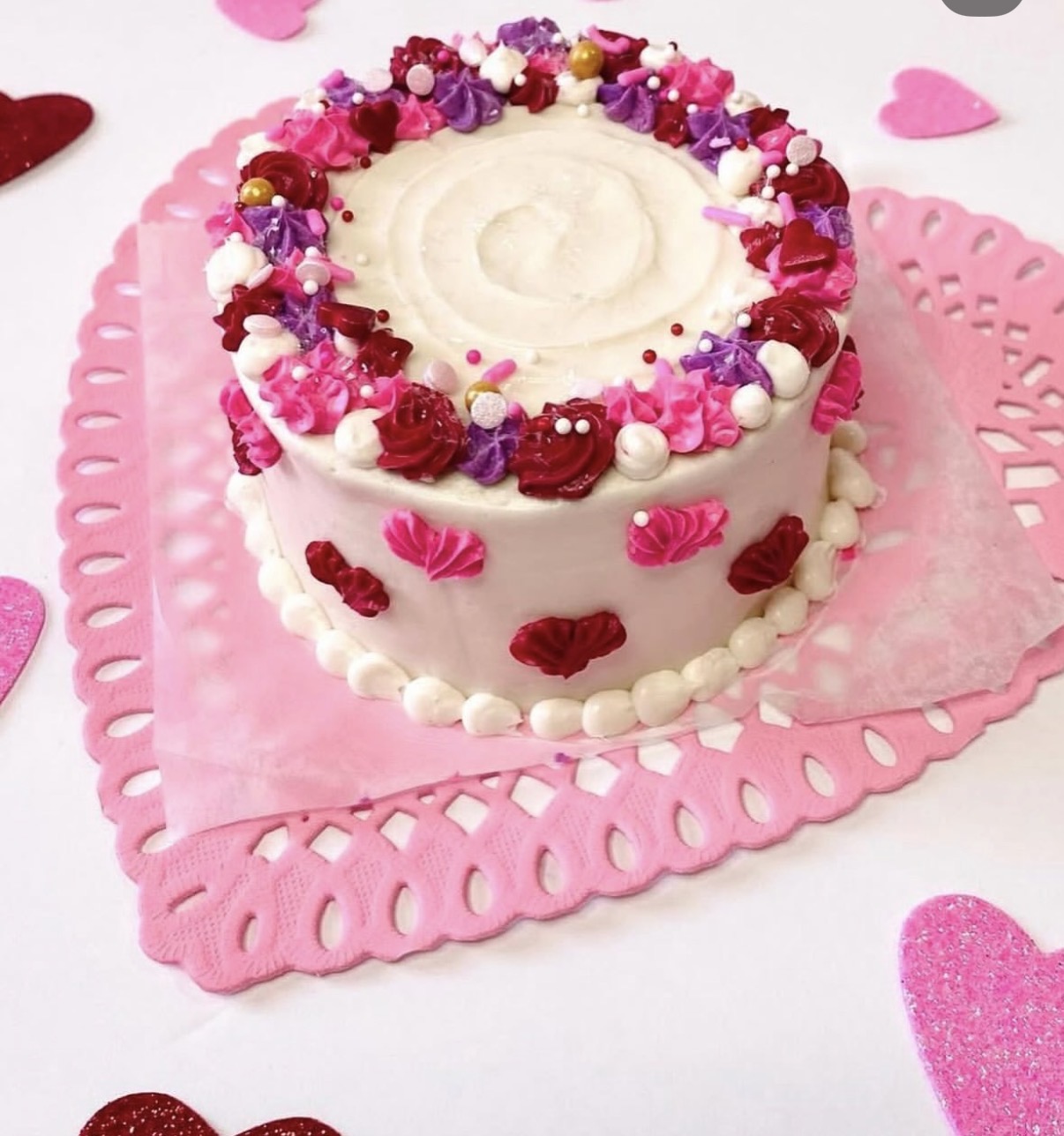 Small pink celebration cake with piped detail